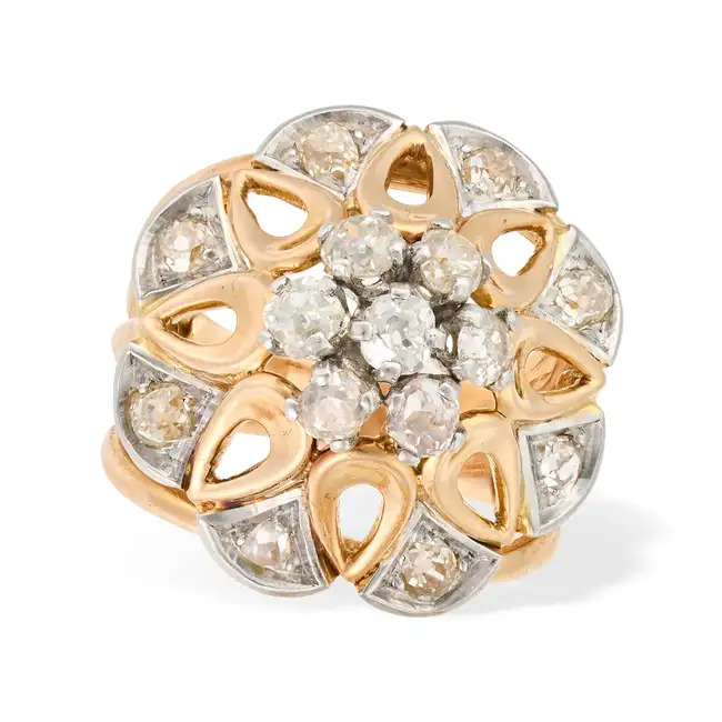 A VINTAGE FRENCH DIAMOND DRESS RING in 18ct yellow gold and platinum, designed as a stylised flower,