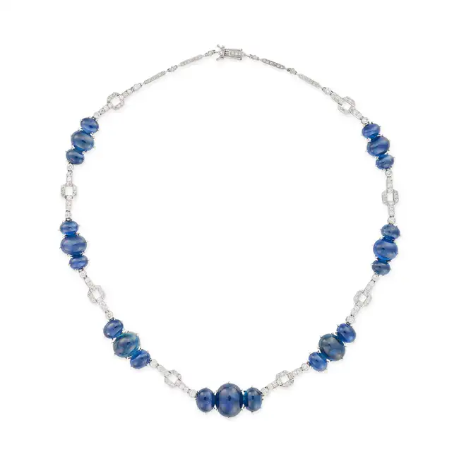 NO RESERVE - A FINE SAPPHIRE AND DIAMOND NECKLACE in 18ct white gold, set with trios of graduated