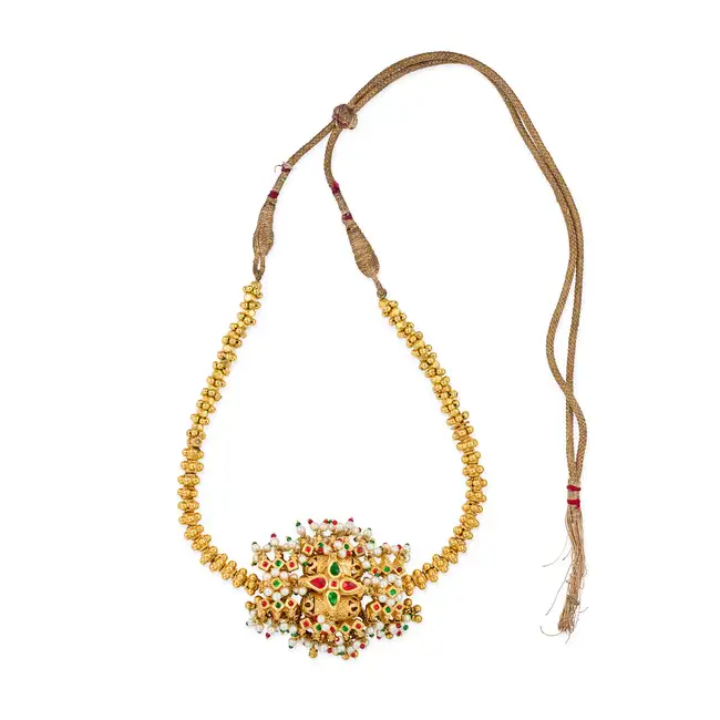 AN INDIAN PEARL NECKLACE the pendant set with pearl and red and glass bead tassels, accented by