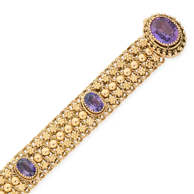 A PORTUGUESE AMETHYST BRACELET in 800 gold fineness, the fancy link bracelet set with oval cut
