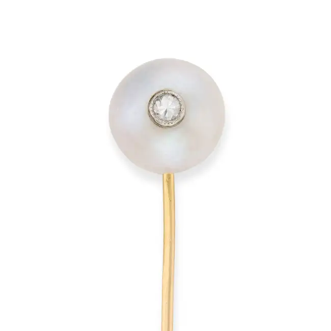 A PEARL AND DIAMOND STICK / TIE PIN comprising a pearl of 11.4mm set with a round brilliant cut