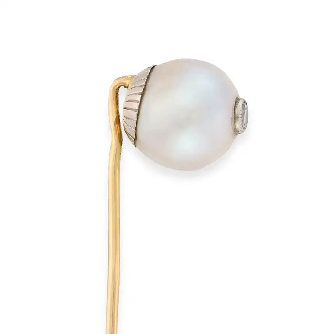 A PEARL AND DIAMOND STICK / TIE PIN comprising a pearl of 11.4mm set with a round brilliant cut