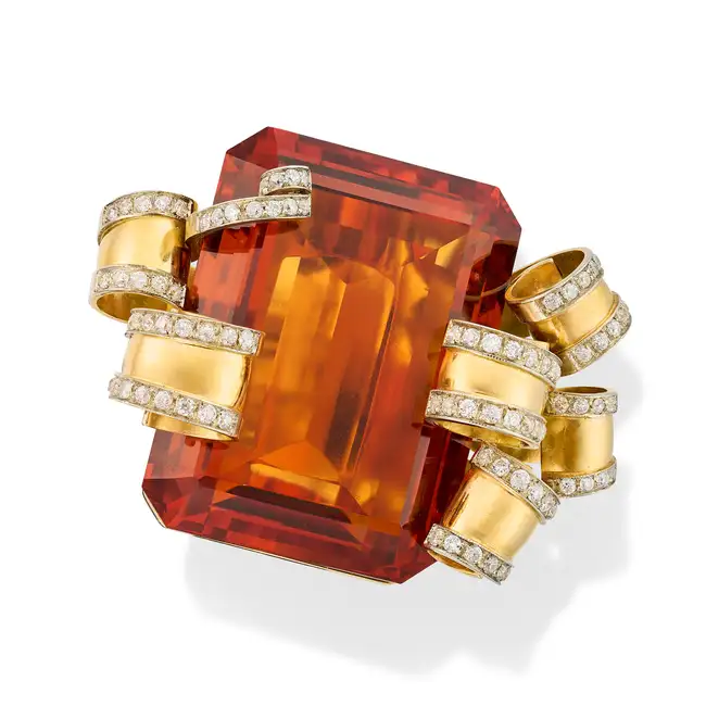A VERY LARGE RETRO CITRINE AND DIAMOND COCKTAIL RING set with an octagonal step cut citrine of