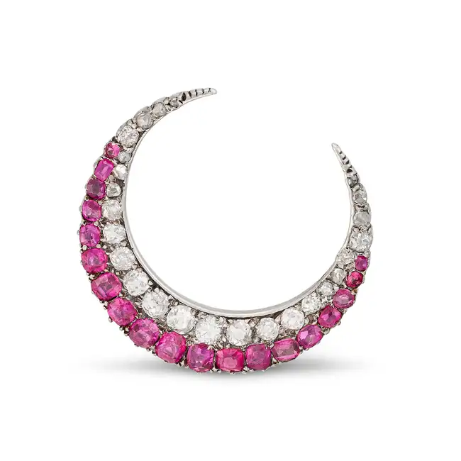 AN ANTIQUE RUBY AND DIAMOND CRESCENT MOON BROOCH in yellow gold and silver, designed as a crescent