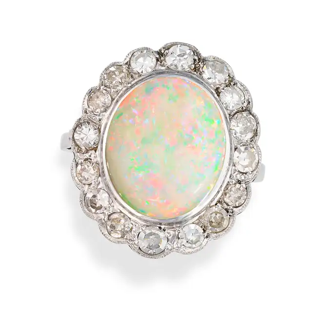 AN OPAL AND DIAMOND CLUSTER RING set with a cabochon opal in a cluster of single cut diamonds, no