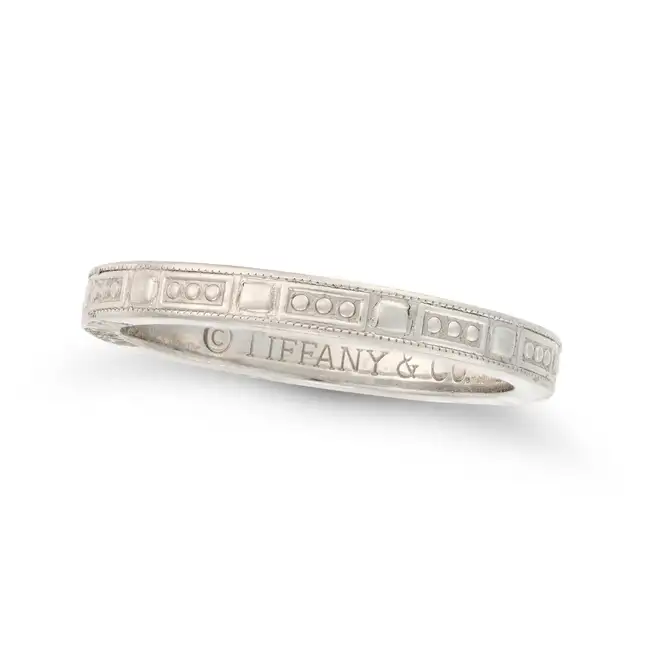 TIFFANY & CO., A PLATINUM BAND RING in platinum, designed as a band engraved with circle and
