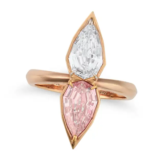 A PINK DIAMOND AND D COLOUR DIAMOND DRESS RING set with a modified pear step cut light pinkish brown