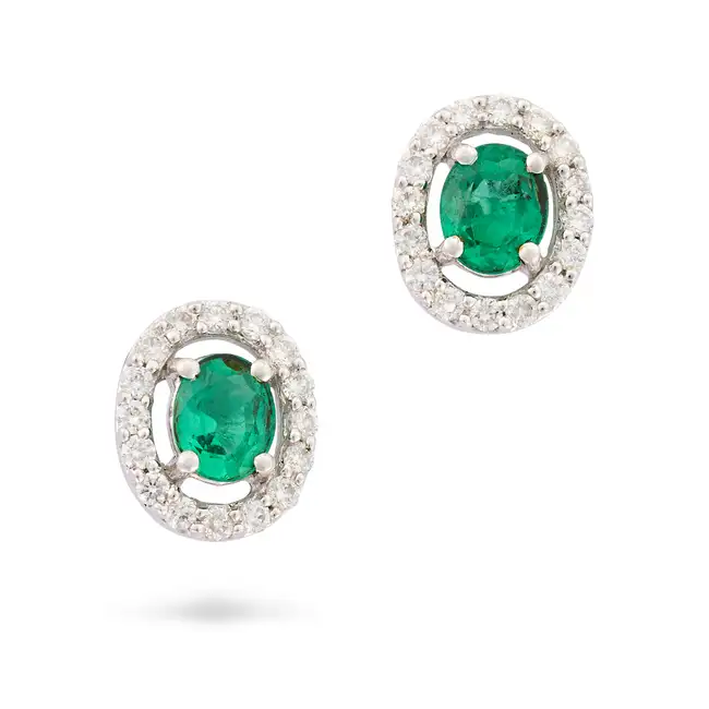 NO RESERVE - A PAIR OF EMERALD AND DIAMOND STUD EARRINGS in 18ct white gold, each set with an oval