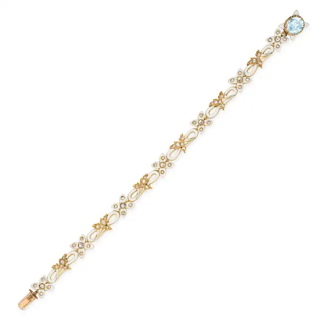 AN ANTIQUE DIAMOND, AQUAMARINE AND ENAMEL BRACELET comprising a row of scrolling links and links
