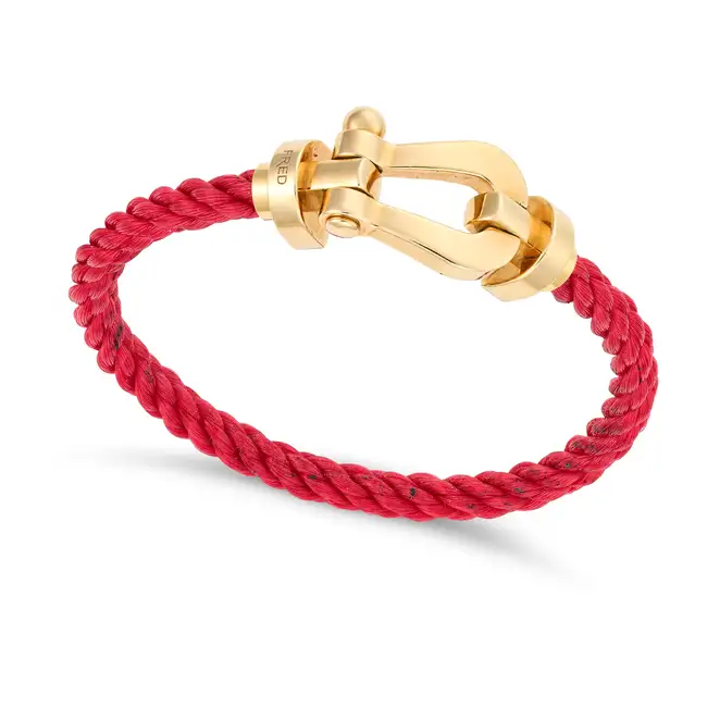 FRED PARIS, A GOLD FORCE 10 BRACELET in 18ct yellow gold, comprising a buckle shaped clasp on a