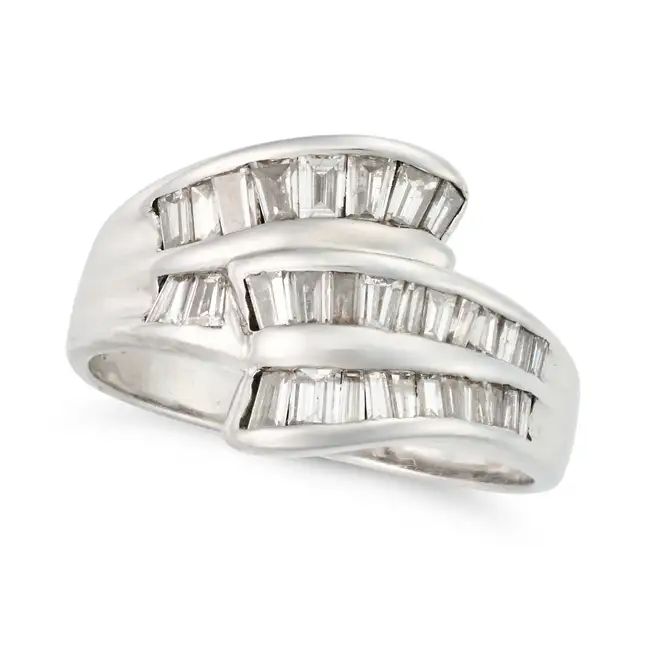 NO RESERVE - A DIAMOND DRESS RING in 18ct white gold, the stylised ring set with rows of baguette