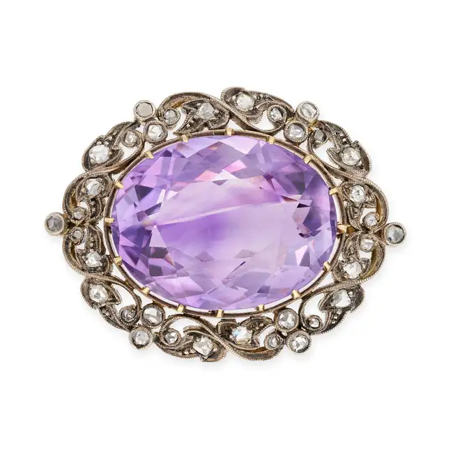 AN ANTIQUE AMETHYST AND DIAMOND BROOCH in yellow gold and silver, set with an oval cut amethyst of