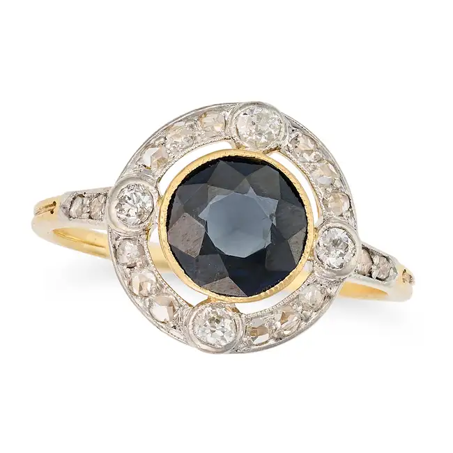 A SAPPHIRE AND DIAMOND DRESS RING set with a round cut sapphire of approximately 1.73 carats in a