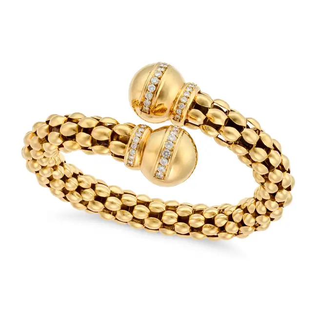 A LARGE DIAMOND BANGLE in crossover design, the tubular bangle comprising rows of fancy links,
