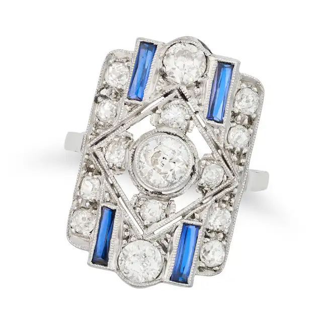 AN ART DECO DIAMOND AND SYNTHETIC SAPPHIRE DRESS RING in platinum, the openwork geometric face set