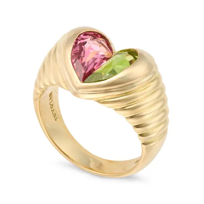 BULGARI, A PINK TOURMALINE AND PERIDOT DOPPIO TONDO RING comprising a heart motif set with a fancy