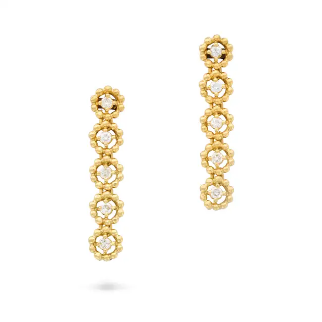 A PAIR OF DIAMOND DROP EARRINGS each comprising a row of round brilliant cut diamonds within