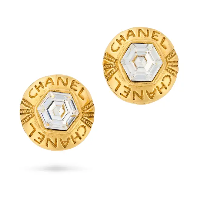 CHANEL, A PAIR OF CRYSTAL LOGO CLIP-ON EARRINGS each comprising a round earring with Chanel logo