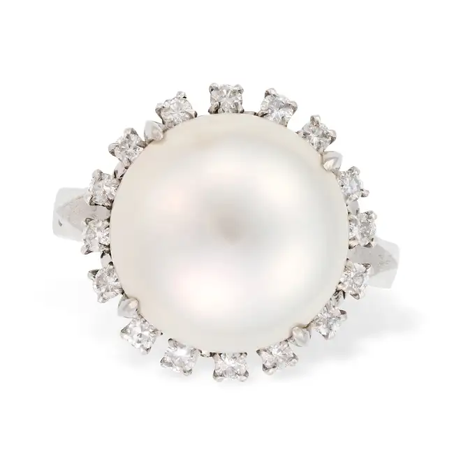 A PEARL AND DIAMOND RING set with a pearl of 12.6mm, accented by round brilliant cut diamonds,