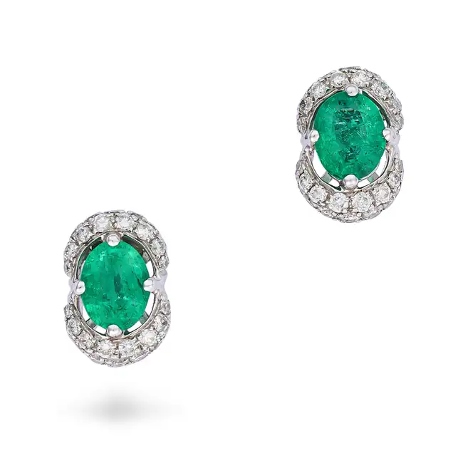 A PAIR OF EMERALD AND DIAMOND STUD EARRINGS each set with an oval cut emerald, accented by pave