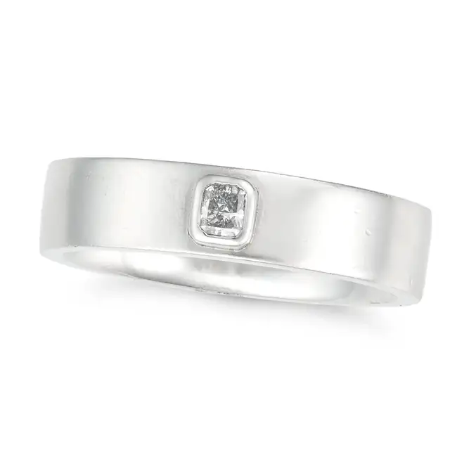 A LIGHT BLUE DIAMOND BAND RING in platinum, set with a radiant cut light blue diamond of 0.12,