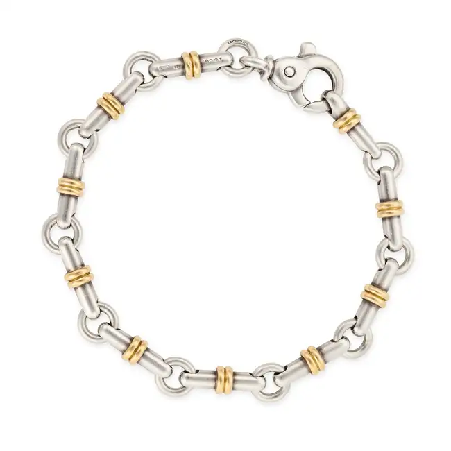 TIFFANY & CO., A SILVER AND GOLD HORSE BIT BRACELET comprising a row of links designed as horse