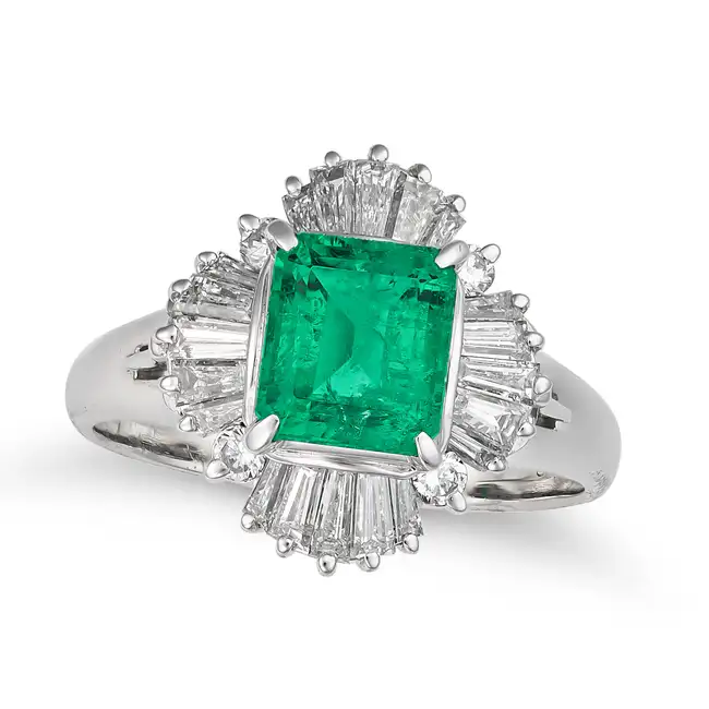 AN EMERALD AND DIAMOND BALLERINA RING set with an octagonal step cut emerald of 1.26 carats,
