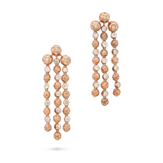 A PAIR OF DIAMOND DROP EARRINGS comprising three articulated row of beads accented by ropework,