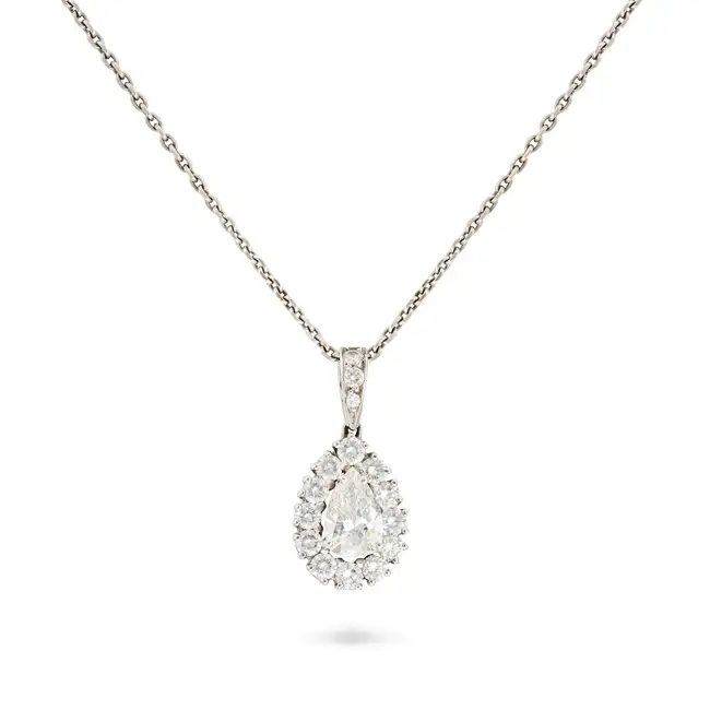 A DIAMOND CLUSTER PENDANT NECKLACE in 18ct white gold, the pendant set with a pear cut diamond of