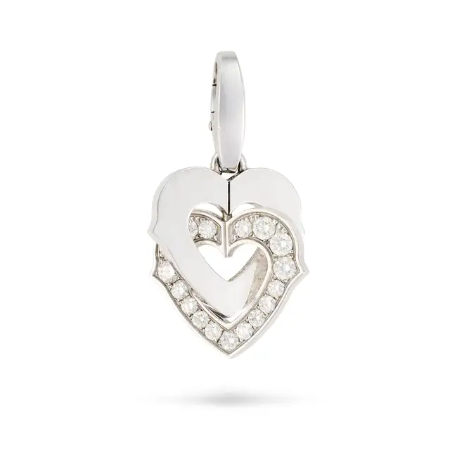 CARTIER, A DIAMOND HEART PENDANT comprising an articulated double heart motif, one set with round