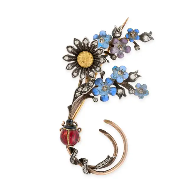 AN ANTIQUE DIAMOND AND ENAMEL FLORAL SPRAY BROOCH in yellow gold and silver, designed as a floral