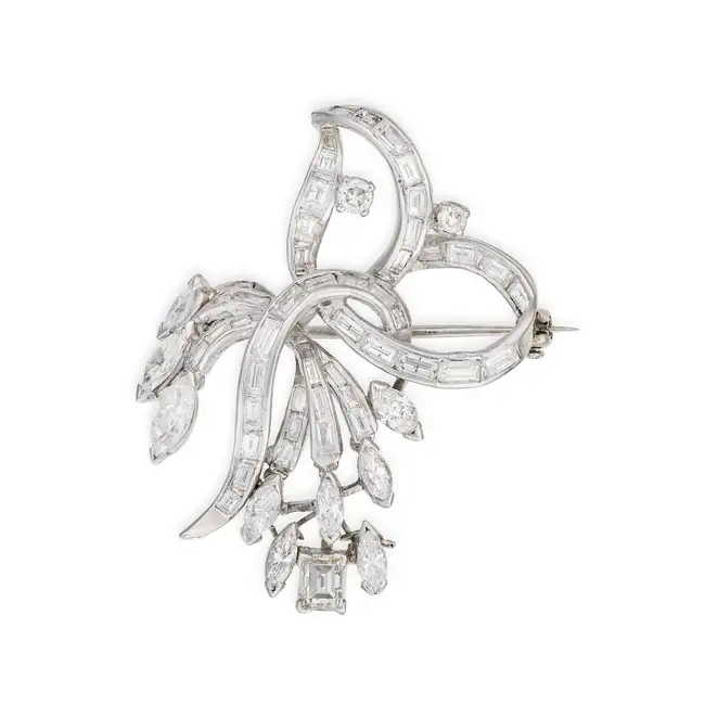 A DIAMOND SPRAY BROOCH designed as a stylised spray set throughout with baguette, marquise and round
