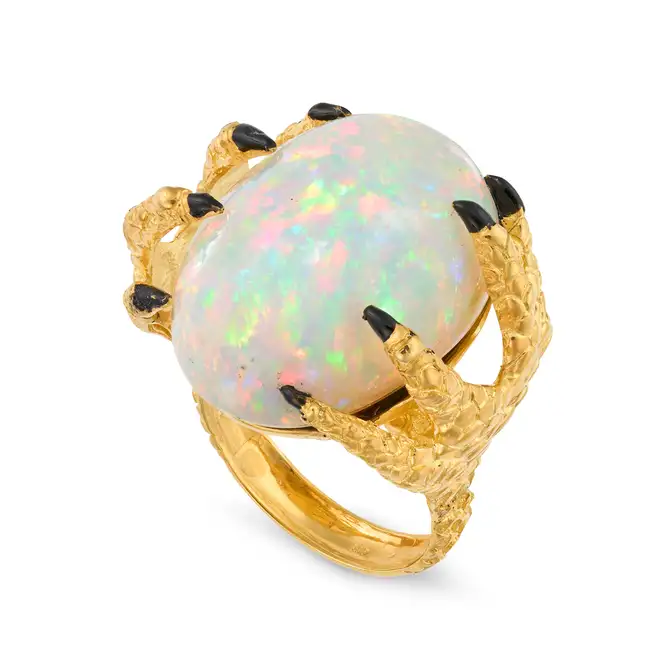 A LARGE OPAL AND ENAMEL CLAW RING in silver gilt, set with a cabochon opal of 38.77 carats, the