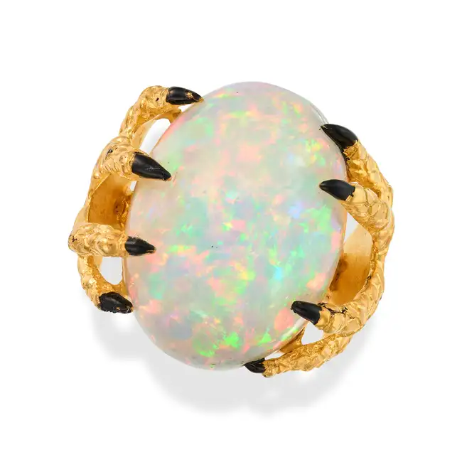 A LARGE OPAL AND ENAMEL CLAW RING in silver gilt, set with a cabochon opal of 38.77 carats, the