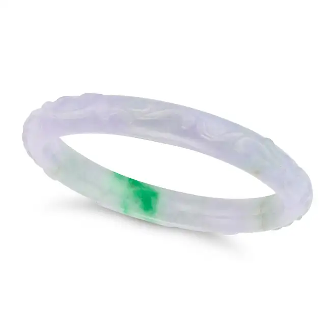 A LAVENDER JADEITE JADE BANGLE comprising a single hoop of carved lavender jade, inner circumference