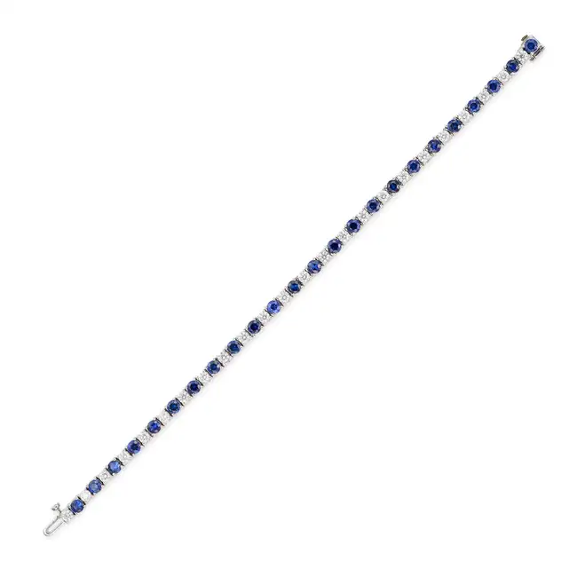 MAPPIN & WEBB, A SAPPHIRE AND DIAMOND LINE BRACELET in 18ct white gold, comprising a row of