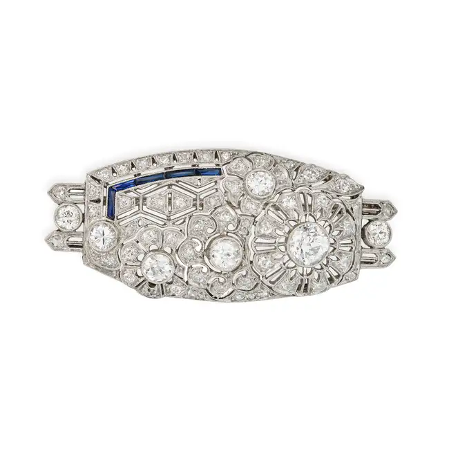 A DIAMOND AND SYNTHETIC SAPPHIRE BROOCH the plaque brooch in openwork foliate design, set with old