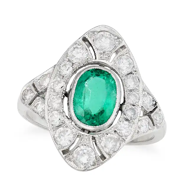 AN EMERALD AND DIAMOND DRESS RING set with an oval cut emerald in a border of round brilliant cut