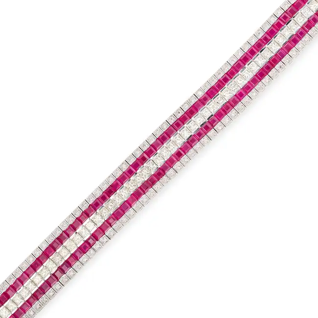 A RUBY AND DIAMOND STRAP BRACELET in 18ct white gold, set with a central row of princess cut