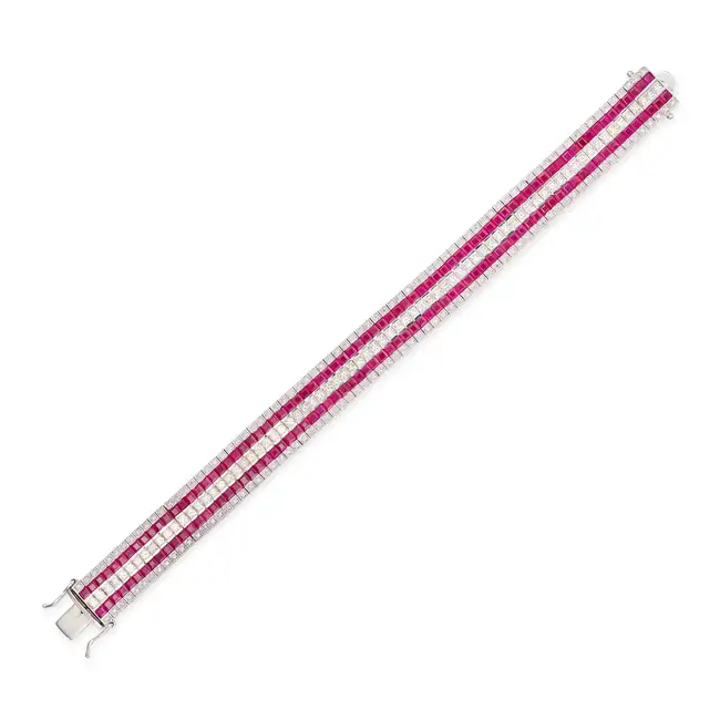 A RUBY AND DIAMOND STRAP BRACELET in 18ct white gold, set with a central row of princess cut