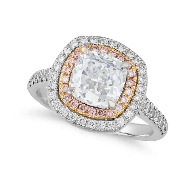 A 2.08 CARAT VERY LIGHT BLUE DIAMOND AND PINK DIAMOND RING in platinum, set with a cushion cut