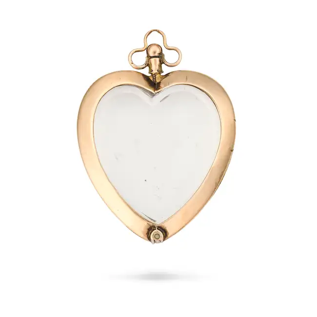 NO RESERVE - AN ANTIQUE ROCK CRYSTAL HEART PENDANT, 1906 in 9ct yellow gold, designed as a heart set