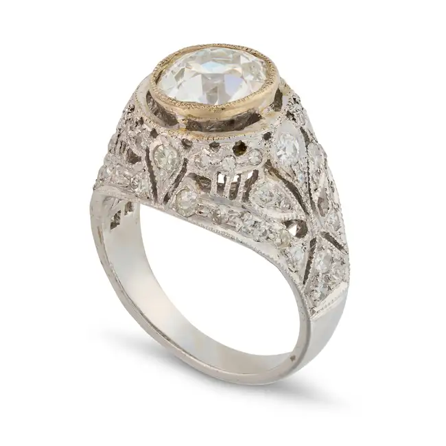 A DIAMOND BOMBE RING set with an old cut diamond of approximately 2.10 carats, the pierced mount set