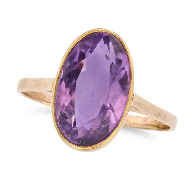 NO RESERVE - AN AMETHYST DRESS RING in 9ct yellow gold, set with an oval cut amethyst to a plain