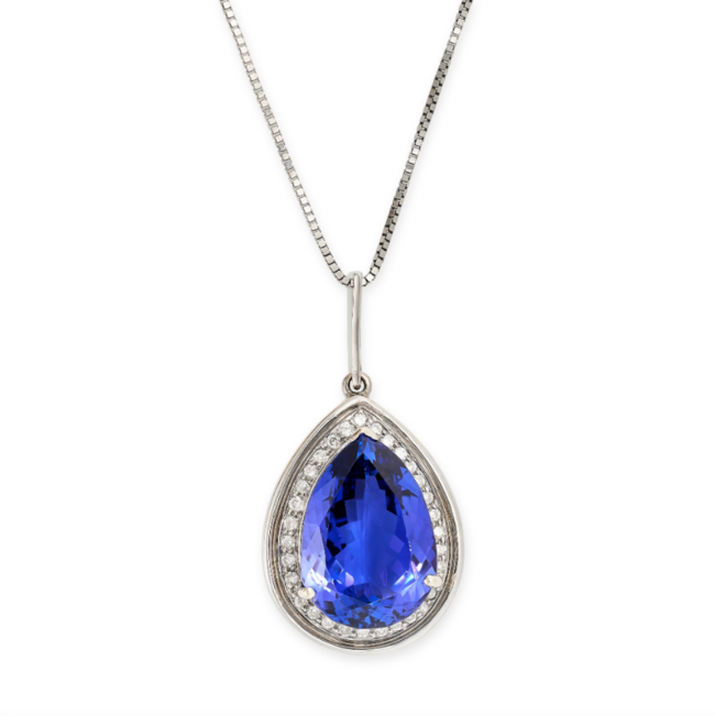 A TANZANITE AND DIAMOND PENDANT AND CHAIN in 18ct white gold and platinum, the pendant set with a pear cut tanzanite of 13.22 carats in a border of round brilliant cut diamonds, suspended from a box link chain, pendant stamped 750, chain stamped 950,