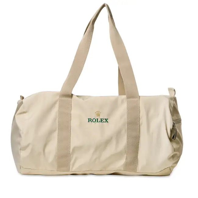 NO RESERVE - ROLEX, A BEIGE SMALL DUFFLE BAG Beige canvas exterior with two handles, a side exterior