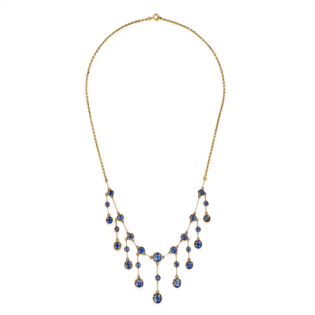 AN ANTIQUE UNHEATED SAPPHIRE FRINGE NECKLACE comprising a trace chain set with a row of oval and