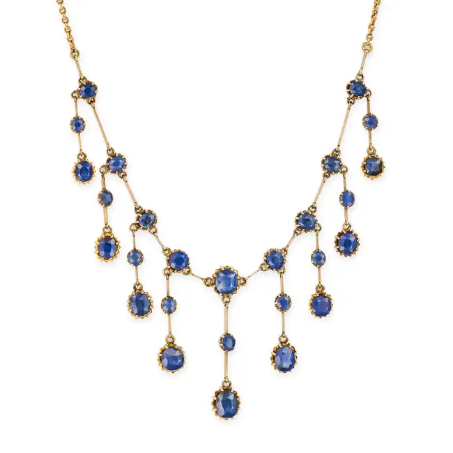 AN ANTIQUE UNHEATED SAPPHIRE FRINGE NECKLACE comprising a trace chain set with a row of oval and