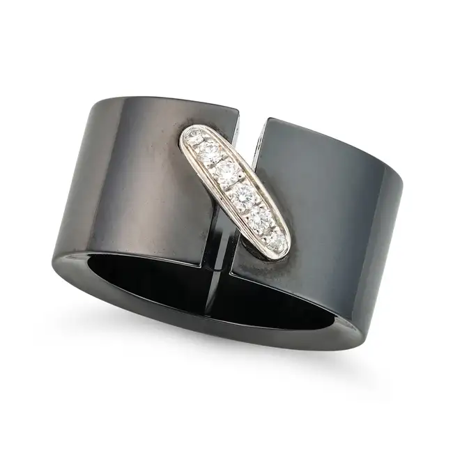 CHAUMET, A DIAMOND AND CERAMIC LIENS RING the black ceramic band accented by a stitch motif set with