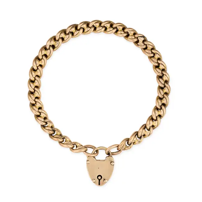 AN ANTIQUE HEART PADLOCK BRACELET in yellow gold, the fancy link bracelet suspending a clasp
